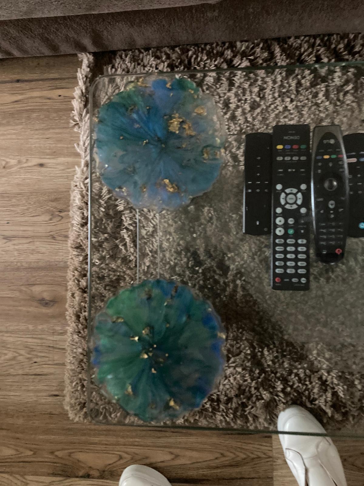 Handmade resin coasters blue/green pattern on a glass coffee table