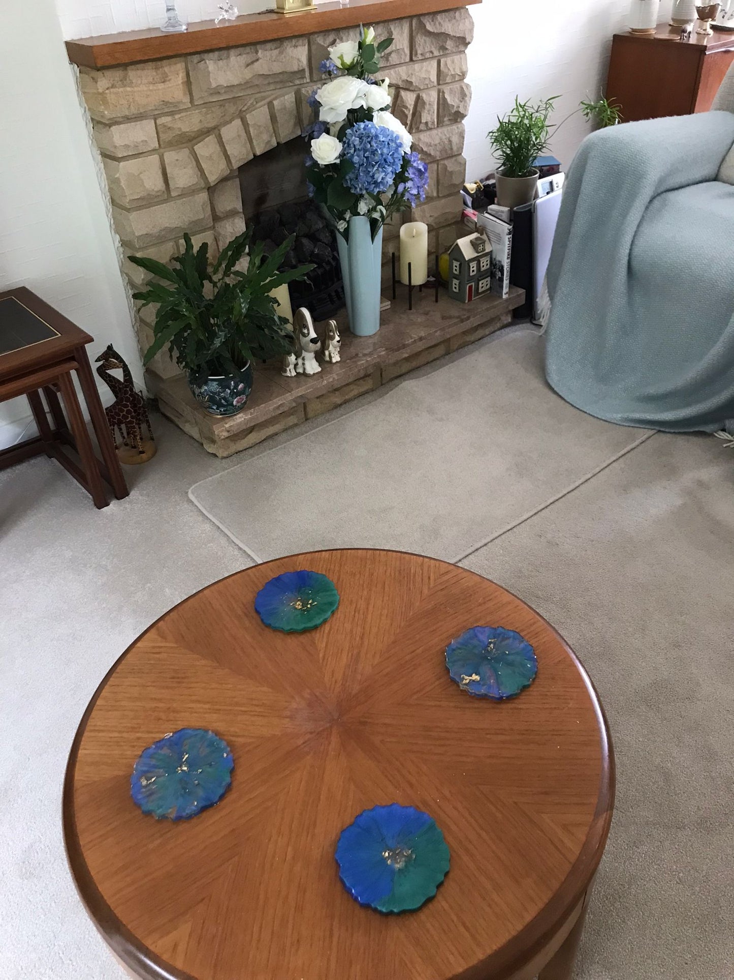 Handmade resin coasters blue/green pattern on a wooden coffee table